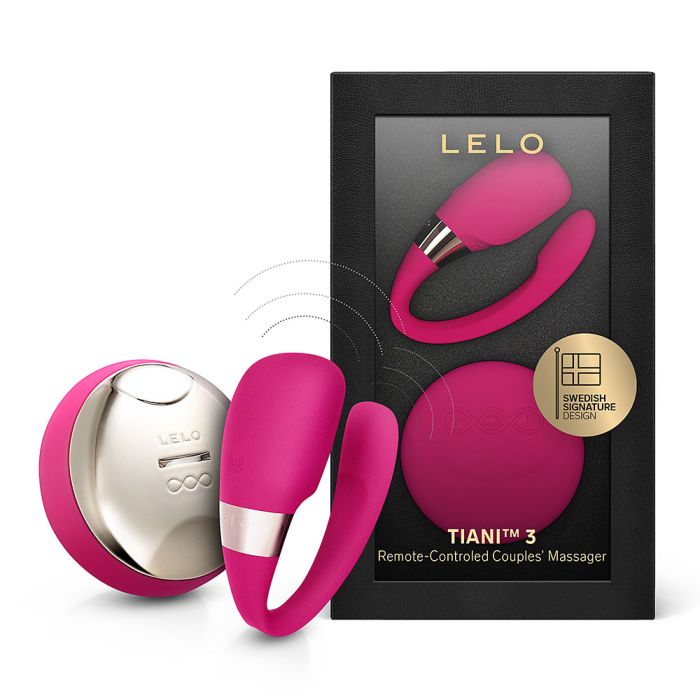 LELO Tiani 3 couples massager in cerise with wireless remote standing next to its retail box.