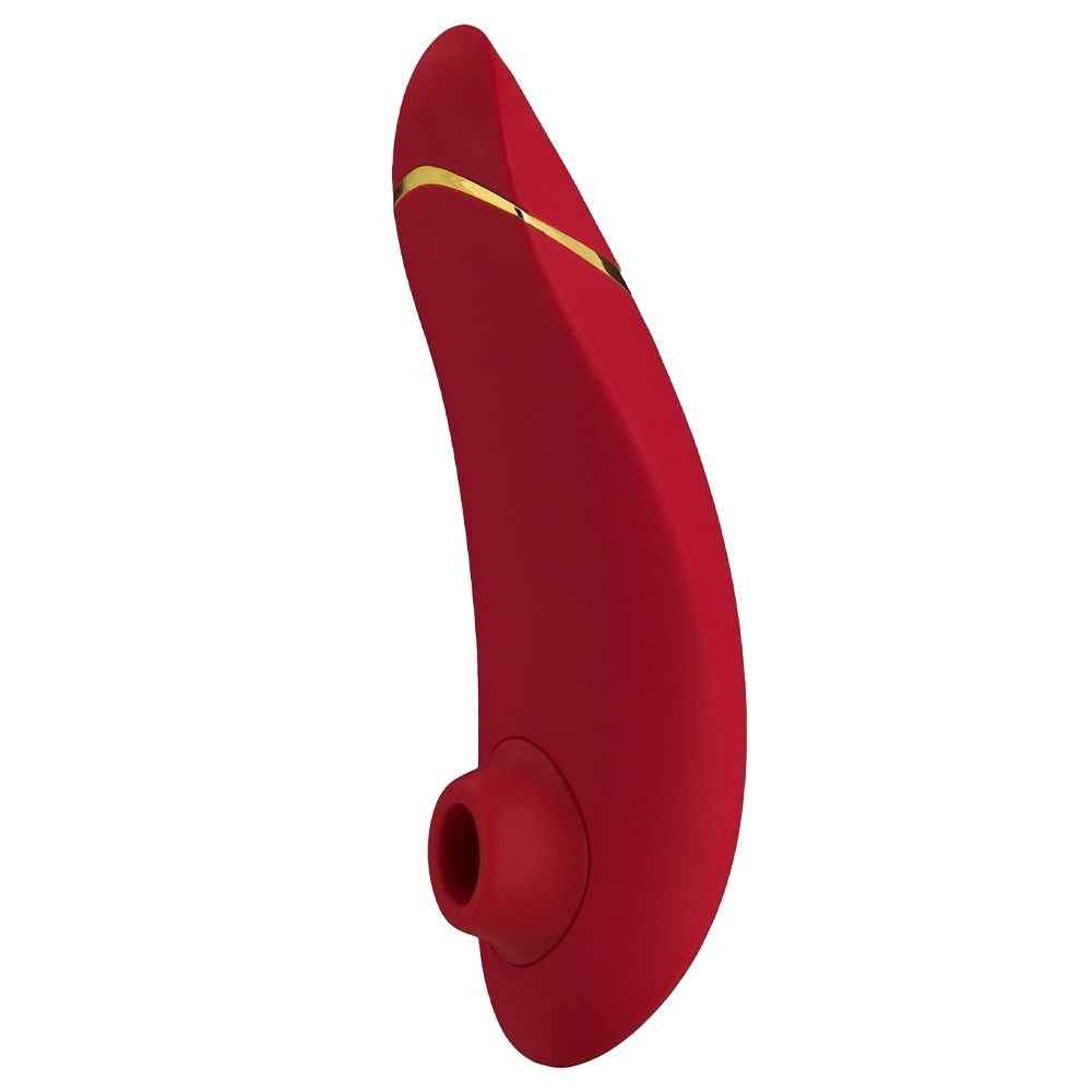 a flat and curved red stimulator with a circular head opening on the front that works as a sucker