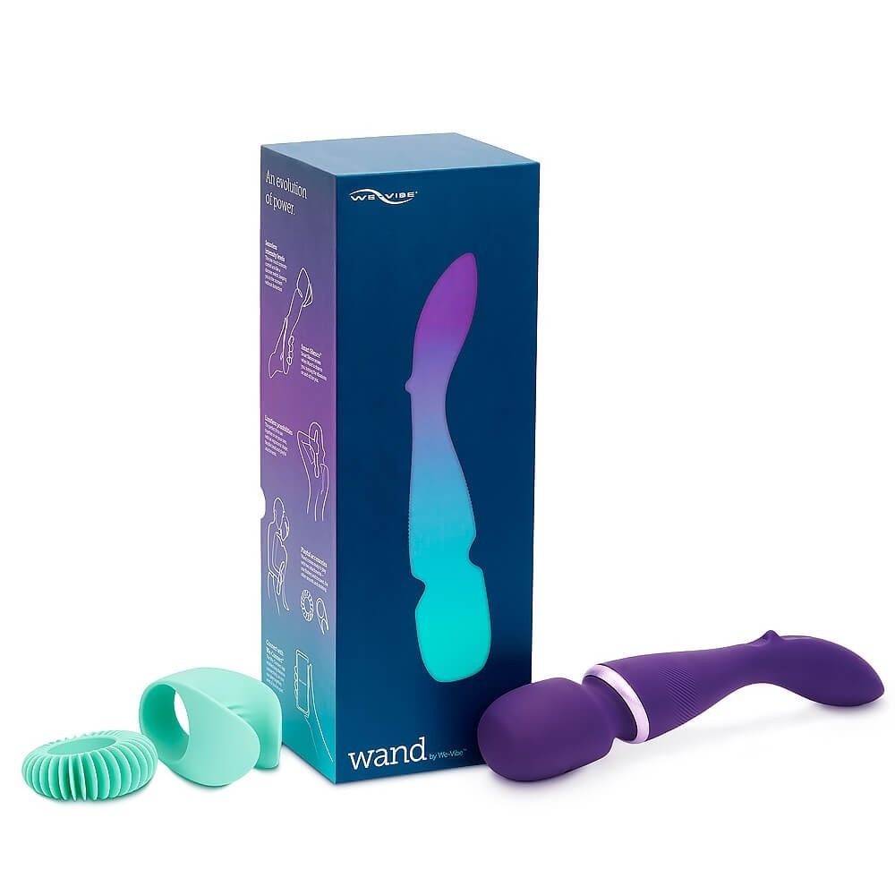 a purple wand vibrator with the usual handle and mushroom head next to its box and two attachments in turquoise, one for the clitoris and one for the penis